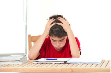 School boy struggling with homework